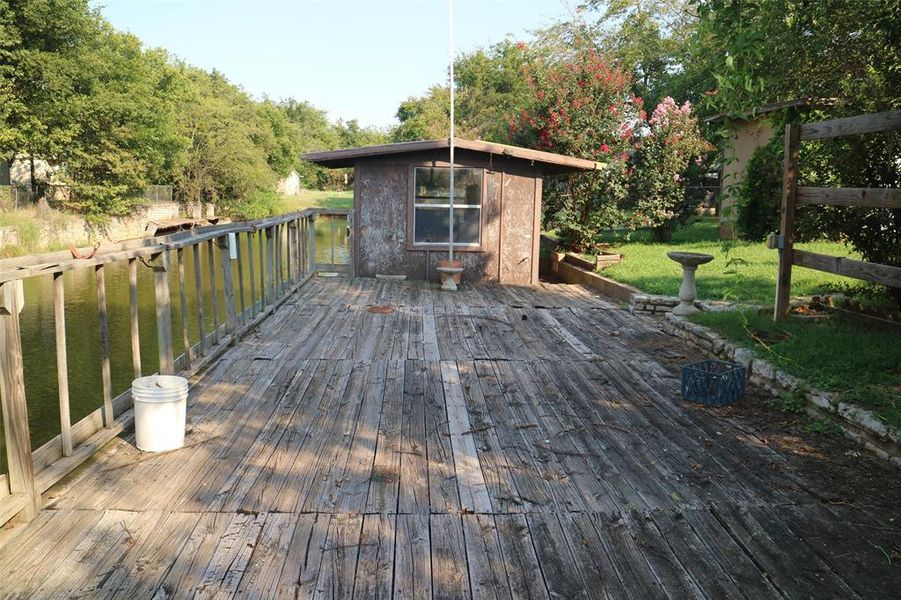 Wooden deck with a water view and a yard Wooden deck with a water view and a yard
