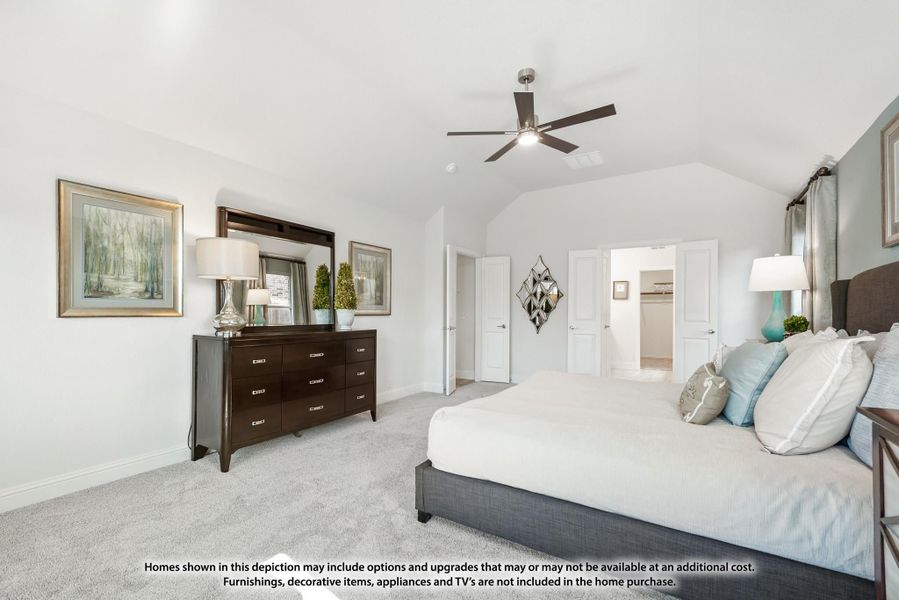 Master bedroom with vaulted ceiling, ceiling fan, carpet flooring, and dark wood dresser with ensuite bathroom visible Master bedroom with vaulted ceiling, ceiling fan, carpet flooring, and dark wood dresser with ensuite bathroom visible