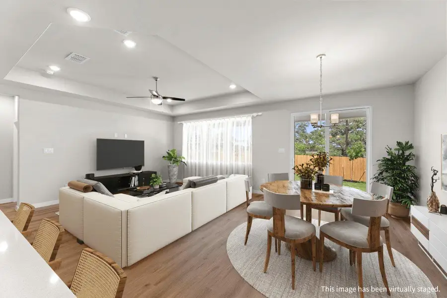 Natural light bathes this combined living and dining space, showcasing rich hardwood floors. Natural light bathes this combined living and dining space, showcasing rich hardwood floors.