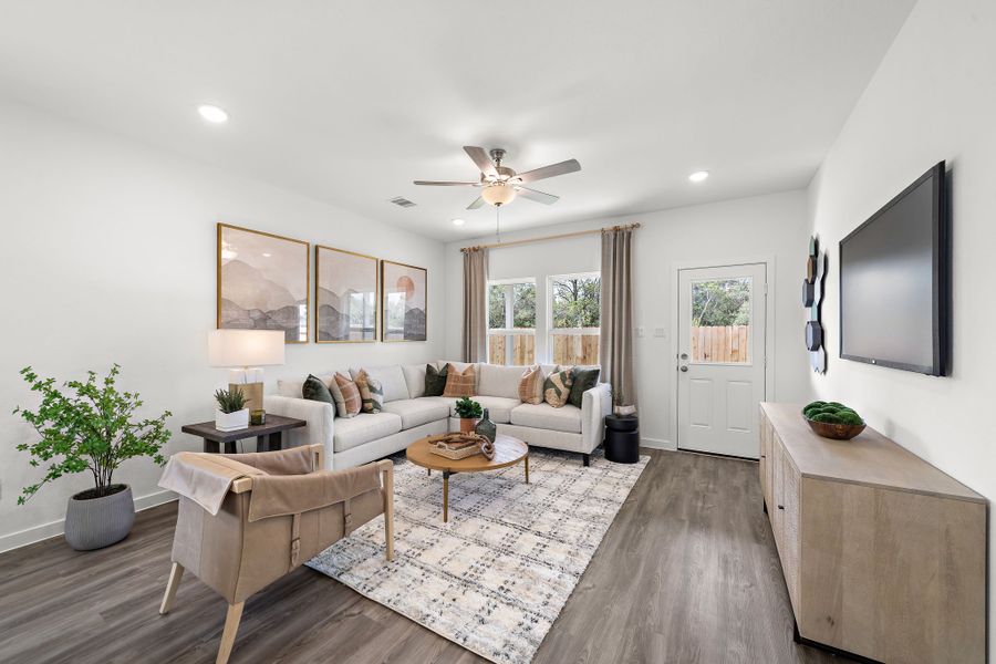 A living room with a couch and a table. A living room with a couch and a table.