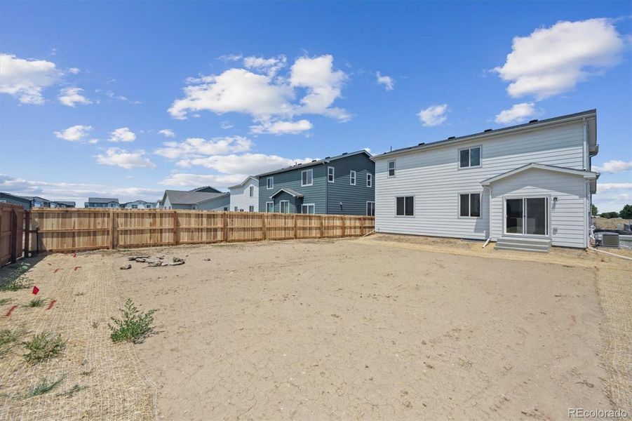 Front exterior of a new home in Farmlore, Brighton, CO, highlighting curb appeal (Image 13).
