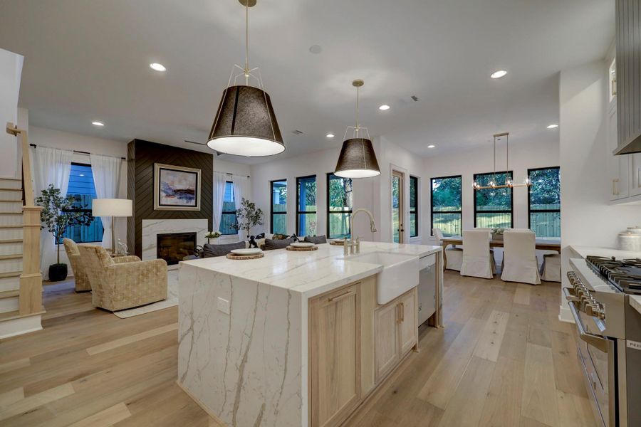 Kitchen features large island with waterfall countertops, farmhouse sink, brass/black accents*photos are of a previously constructed home by the builder. 1527 Hewitt may have different selections at builders sole discretion. These photos are not meant to be an exact representation of 1527 Hewitt.