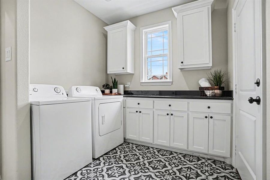 Laundry area featuring cabinet space and washer and clothes dryer