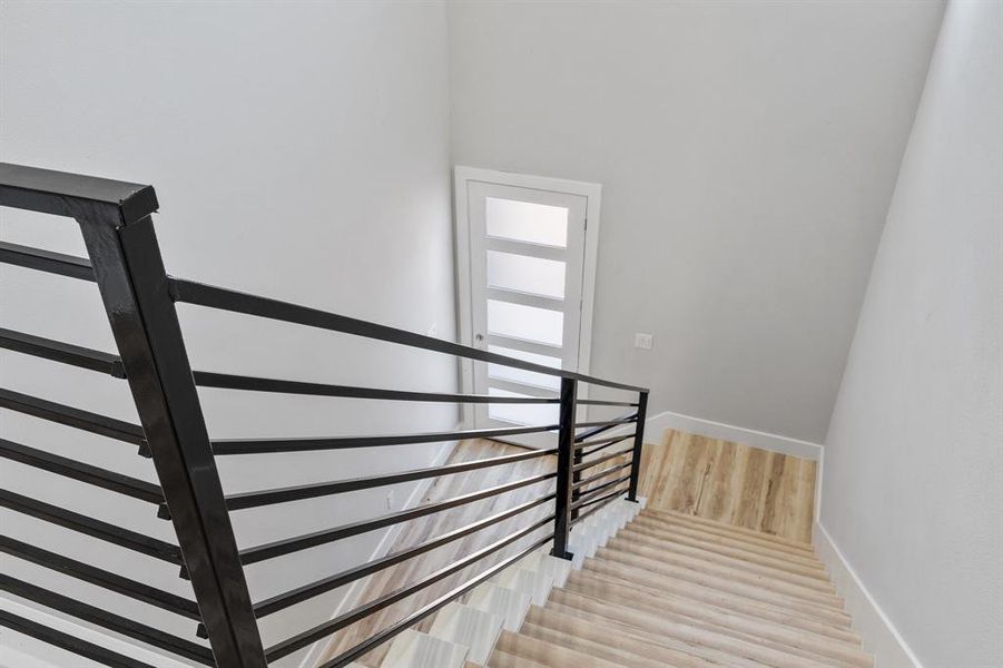 Stairway featuring wood-type flooring