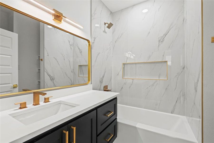 Full bathroom with vanity and a combined bath / shower with marble appearance