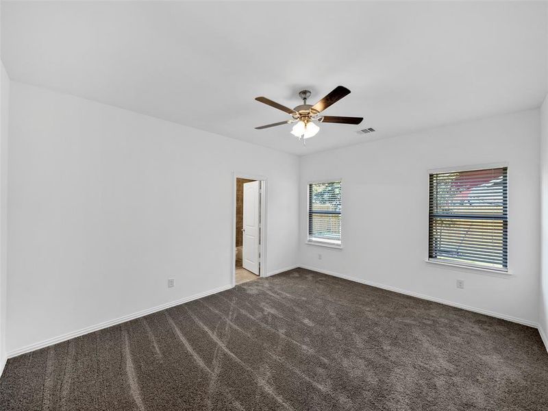 Spare room featuring carpet floors and ceiling fan