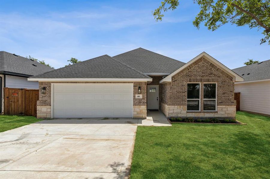 Single story home featuring a garage and a front lawn