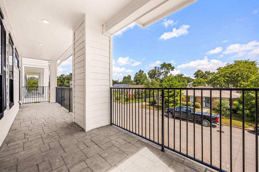 A peaceful balcony view overlooking open skies through the sleek iron railing.