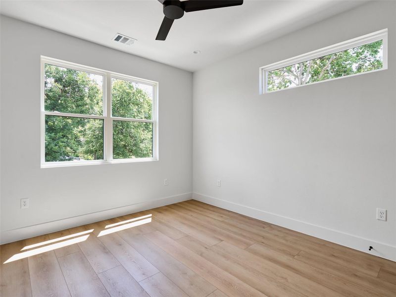 Unfurnished room with ceiling fan and light wood-type flooring Unfurnished room with ceiling fan and light wood-type flooring