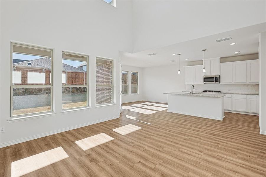 Unfurnished living room featuring light wood finished floors and recessed lighting