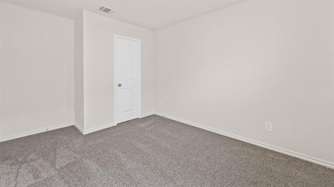 Neutral wall finishes, textured gray carpeting, and white baseboards
