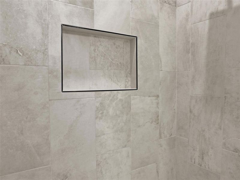 Room details with tiled shower