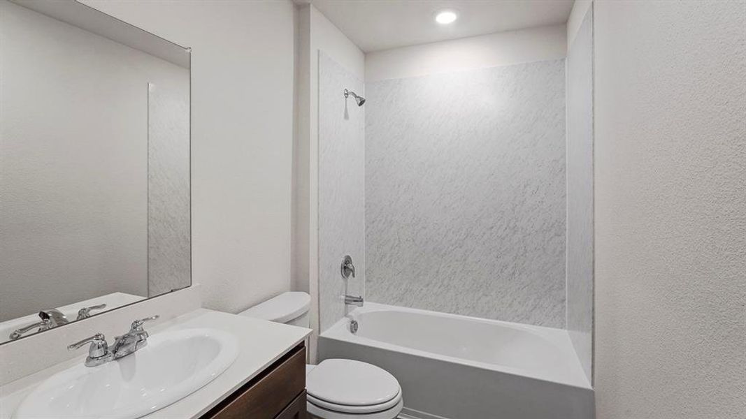 Bathroom featuring a white vanity with a rectangular sink, chrome faucet, and integrated mirror