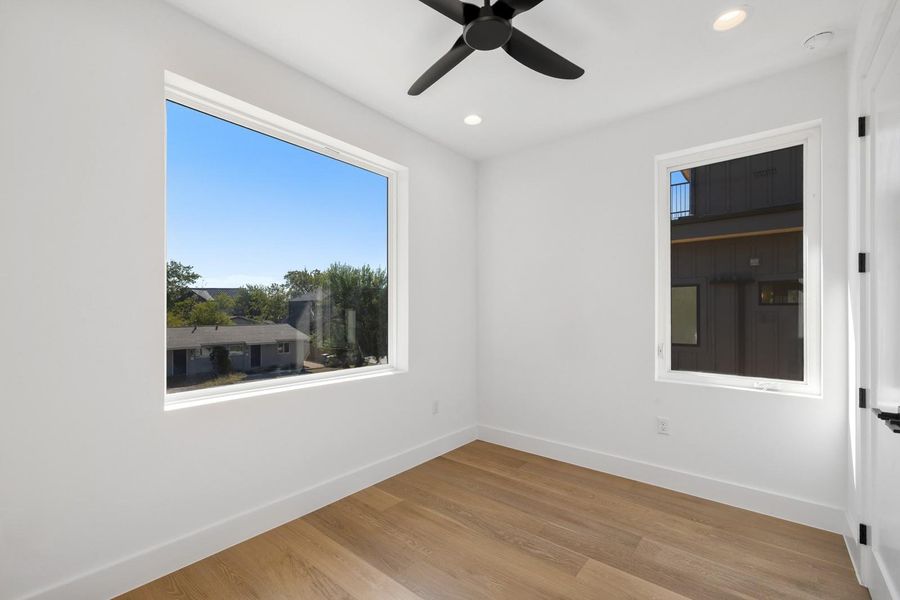 Unfurnished room with light wood-type flooring, recessed lighting, and ceiling fan Unfurnished room with light wood-type flooring, recessed lighting, and ceiling fan