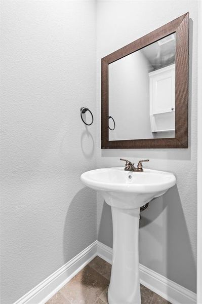Half Bathroom featuring pedestal sink. Half Bathroom featuring pedestal sink.