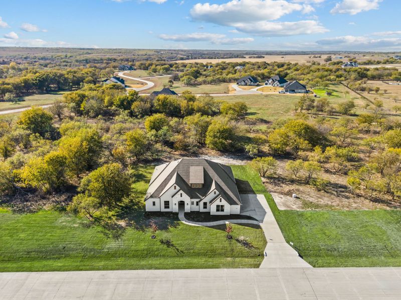 Front exterior of a new home in Rolling Creek Ranch, Aledo, TX, highlighting curb appeal (Image 2). Front exterior of a new home in Rolling Creek Ranch, Aledo, TX, highlighting curb appeal (Image 2).