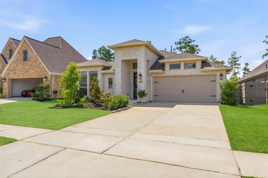 Front exterior of a new home in Artavia, Conroe, TX, highlighting curb appeal (Image 26). Front exterior of a new home in Artavia, Conroe, TX, highlighting curb appeal (Image 26).