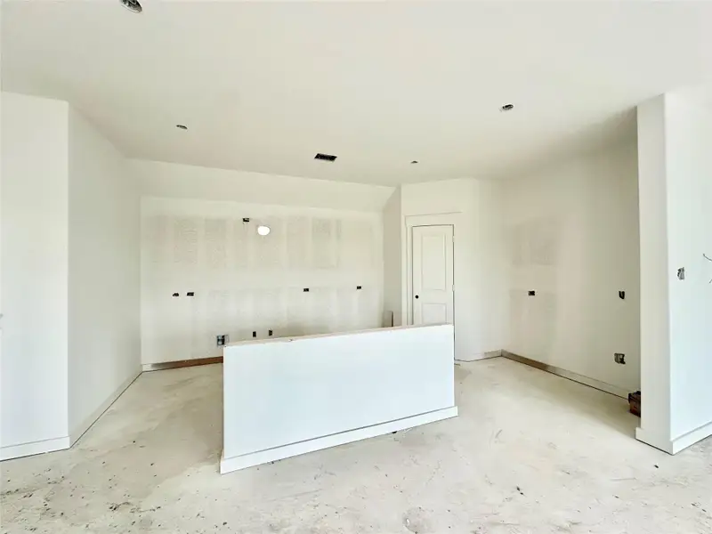Empty room featuring unfinished concrete flooring