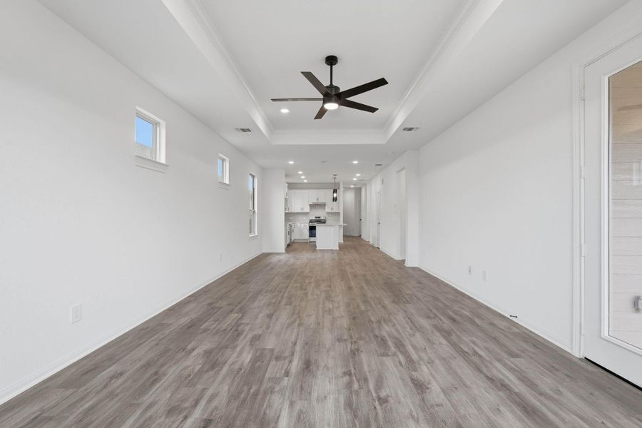 The open-concept design truly shines, with the living area flowing effortlessly into a bright kitchen featuring abundant cabinet space and stainless steel appliances.