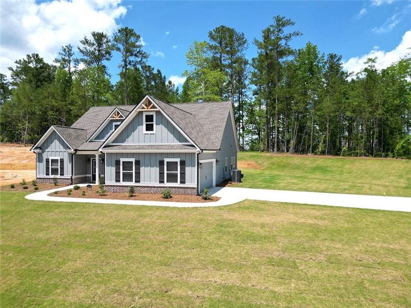 Front exterior of a new home in Woodland Hills, Loganville, GA, highlighting curb appeal (Image 1). Front exterior of a new home in Woodland Hills, Loganville, GA, highlighting curb appeal (Image 1).