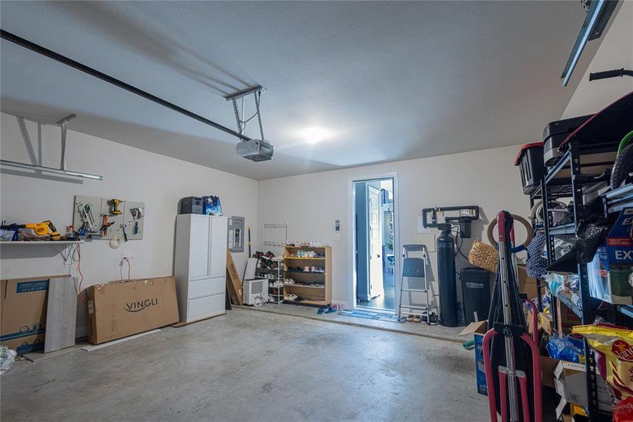 Garage with electric panel and a garage door opener
