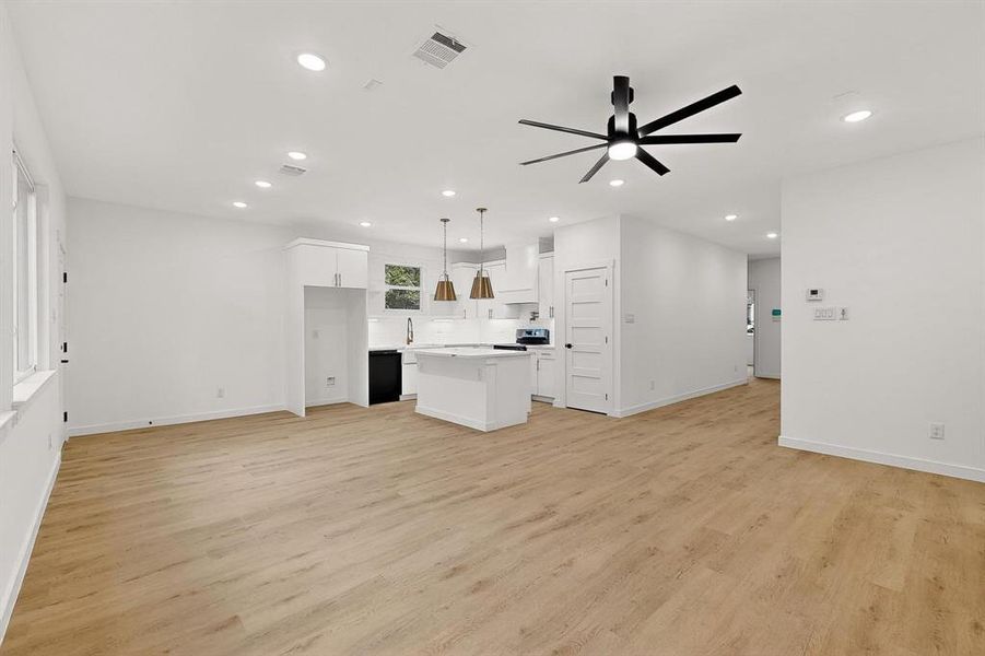 Unfurnished living room featuring recessed lighting, light wood-type flooring, and a ceiling fan Unfurnished living room featuring recessed lighting, light wood-type flooring, and a ceiling fan