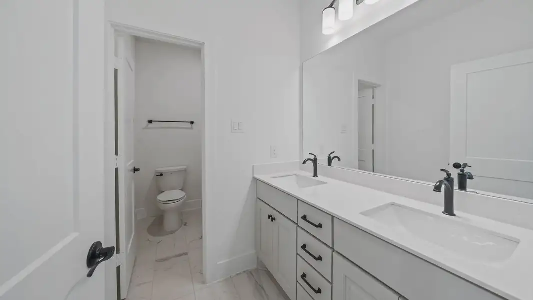 Representative furnished interior of a home built from the Waterloo by Chesmar Homes in Sofi Lakes, Katy (Image 14).