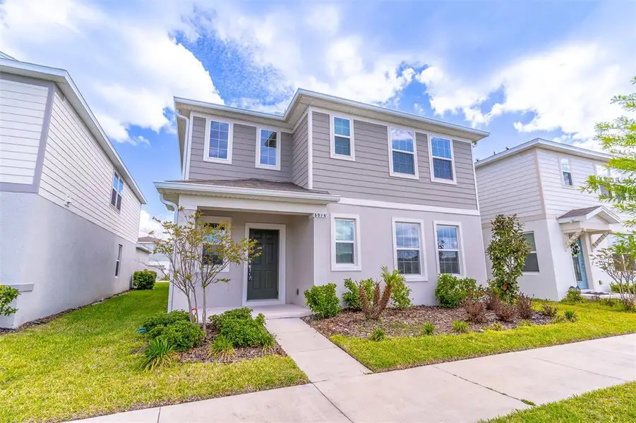 Front exterior of a new home in , St. Cloud, FL, highlighting curb appeal (Image 27).