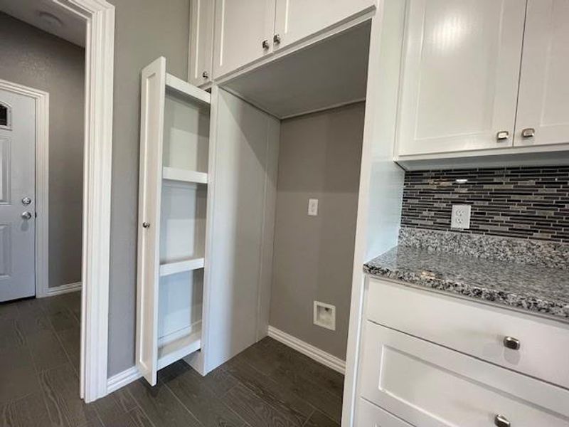 Kitchen with custom pullout storage next to fridge Kitchen with custom pullout storage next to fridge