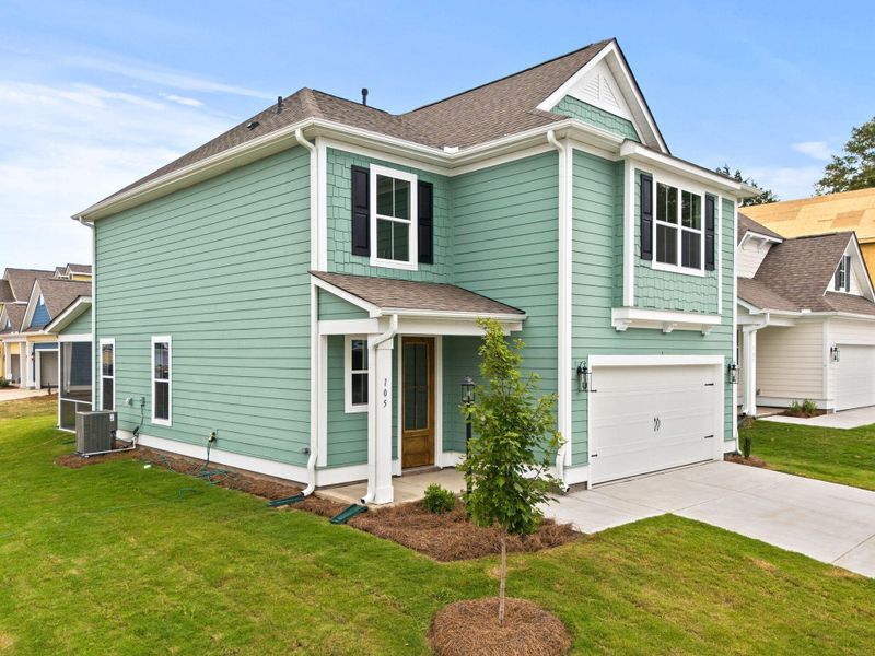 Front exterior of a new home in Sweetgrass Station, Summerville, SC, highlighting curb appeal (Image 18).