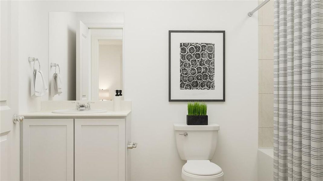 Full bathroom featuring vanity, shower / tub combo, and toilet