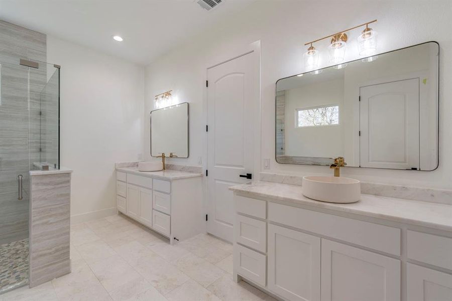 Bathroom featuring an enclosed shower and vanity