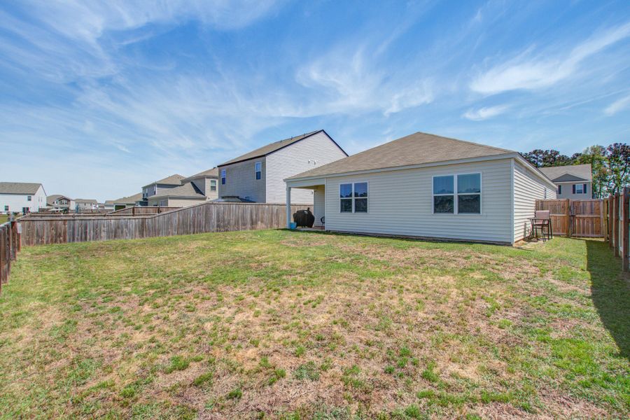 Exterior details and patio area of a home in Pine Hills at Cane Bay, Summerville (Image 25).