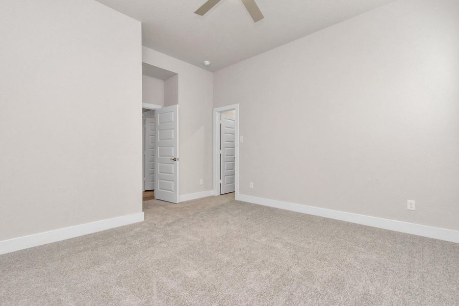 Elegance meets functionality in the generously sized secondary bedrooms, showcasing 5-panel doors with modern hardware, large windows adorned with privacy blinds, and spacious closets boasting sleek and contemporary finishes. Sample photo of completed home with similar floor plan. Actual colors and selections may vary. Elegance meets functionality in the generously sized secondary bedrooms, showcasing 5-panel doors with modern hardware, large windows adorned with privacy blinds, and spacious closets boasting sleek and contemporary finishes. Sample photo of completed home with similar floor plan. Actual colors and selections may vary.