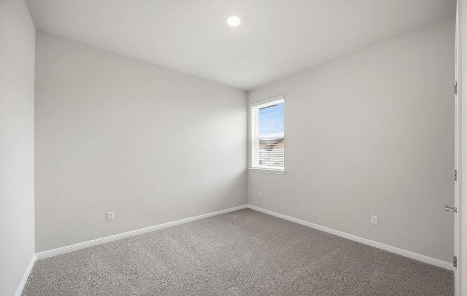 Empty room featuring baseboards and carpet flooring