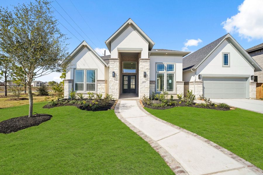 Spectacular elevation of brick, stone and stucco, artfully lit with soffit lights Spectacular elevation of brick, stone and stucco, artfully lit with soffit lights