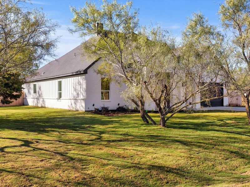 View of side of home featuring a yard and a chimney
