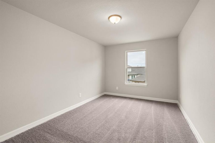 Your secondary bedroom features plush carpet, fresh paint, closet, and a large window that lets in plenty of natural lighting.