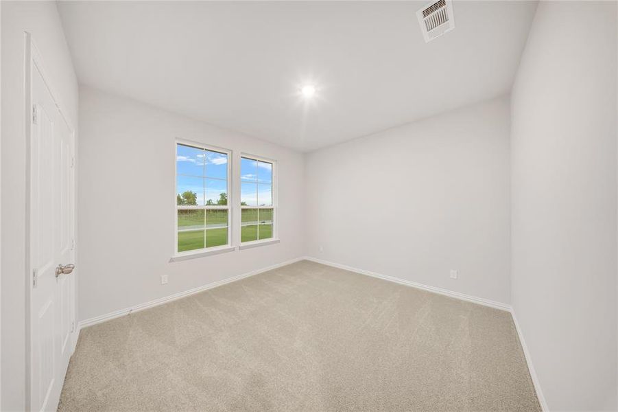 Carpeted empty room with baseboards Carpeted empty room with baseboards