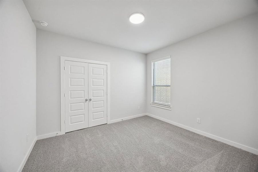 Bedroom in the Wimbledon home plan by Trophy Signature Homes – REPRESENTATIVE PHOTO