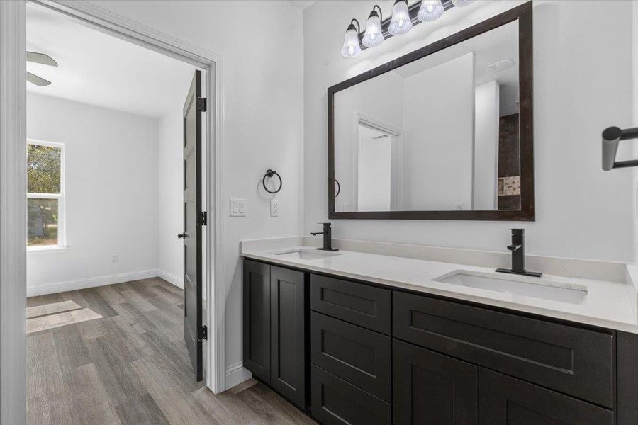 Clean lines and a double vanity define this contemporary primary bathroom space. Clean lines and a double vanity define this contemporary primary bathroom space.