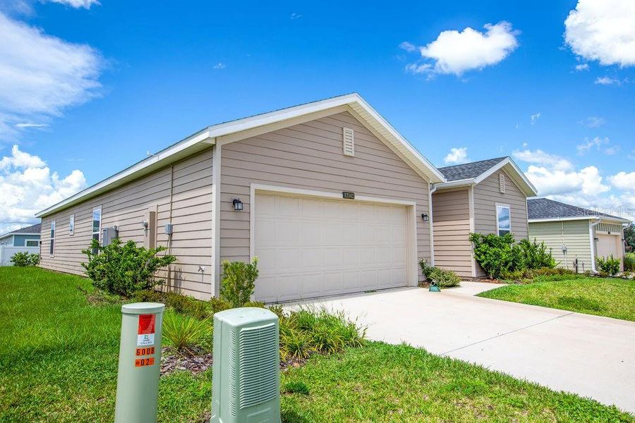 Front exterior of a new home in Trailhead Landing, Alachua, FL, highlighting curb appeal (Image 27).