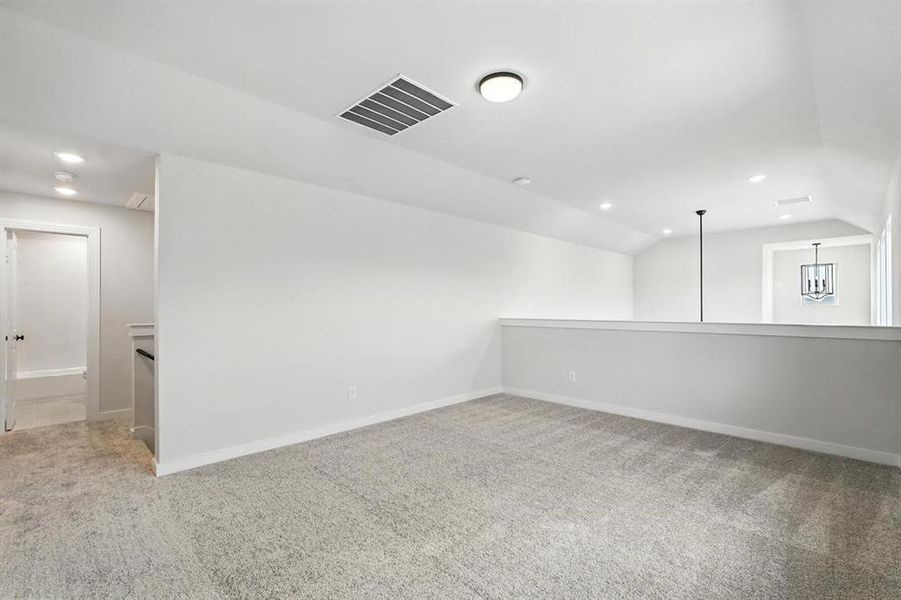 Additional living space with light carpet, lofted ceiling, and recessed lighting Additional living space with light carpet, lofted ceiling, and recessed lighting