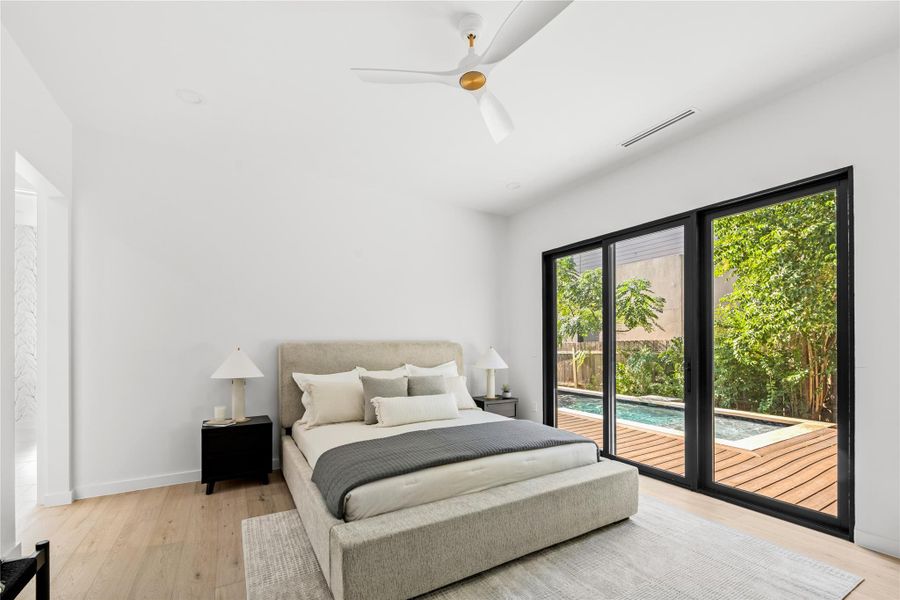 Bedroom featuring access to exterior, light wood-type flooring, and ceiling fan