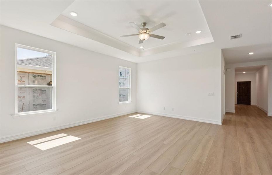 Gathering room drenched in natural light, creating a warm atmosphere  *Real home pictured