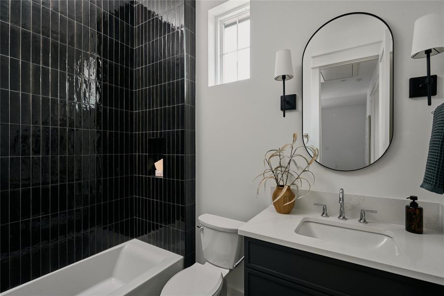 Full bath featuring vanity, toilet, and bathing tub / shower combination Full bath featuring vanity, toilet, and bathing tub / shower combination