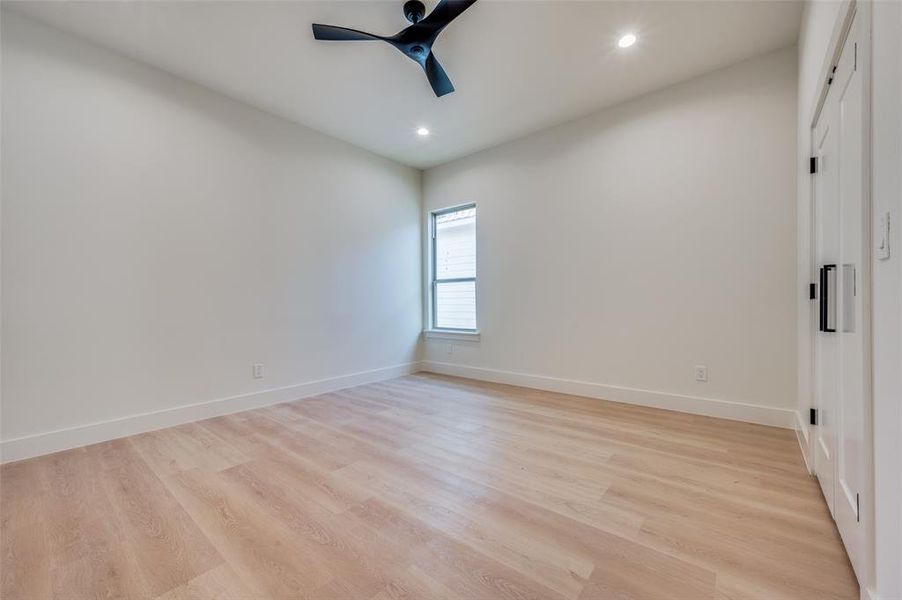 Unfurnished bedroom featuring ceiling fan and light hardwood / wood-style flooring