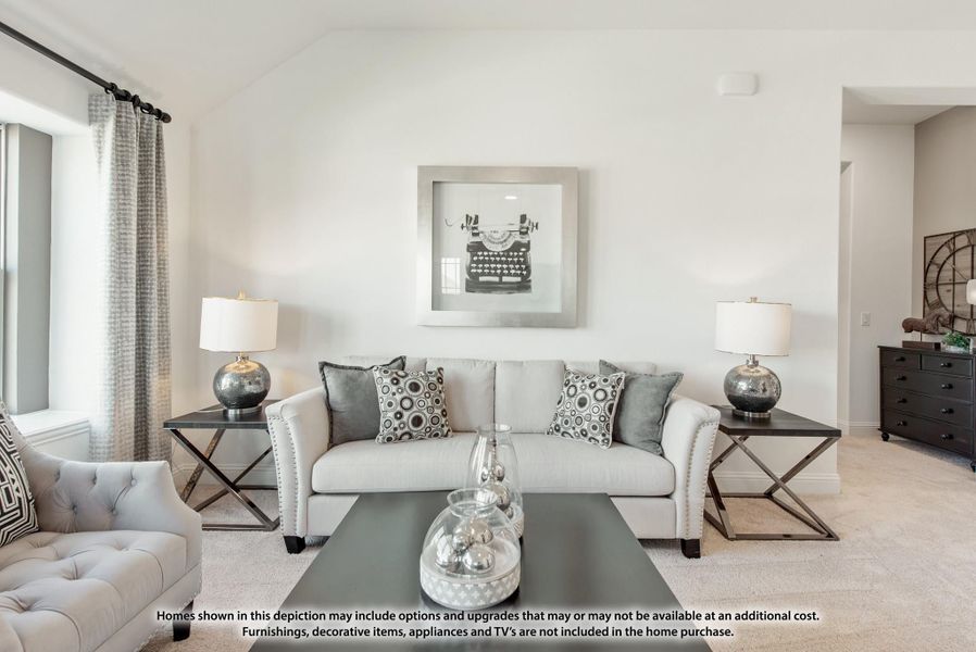 Living room with light gray sofa, decorative pillows, two table lamps, and framed wall art above the couch