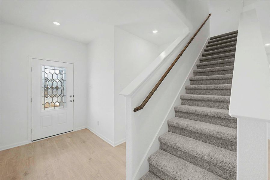 Entryway with light wood-type flooring and recessed lighting