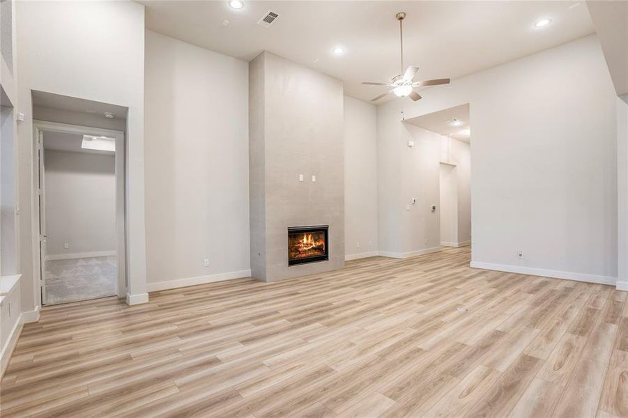 Family Room with Dramatic Gas-log Fireplace and Floor Outlet